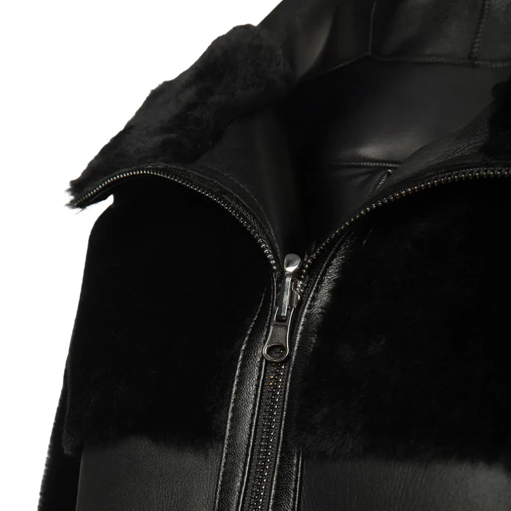 Close-up of the Elena jacket’s reversible texture, showing the contrast between the matte black leather and the thick, curly shearling lining.