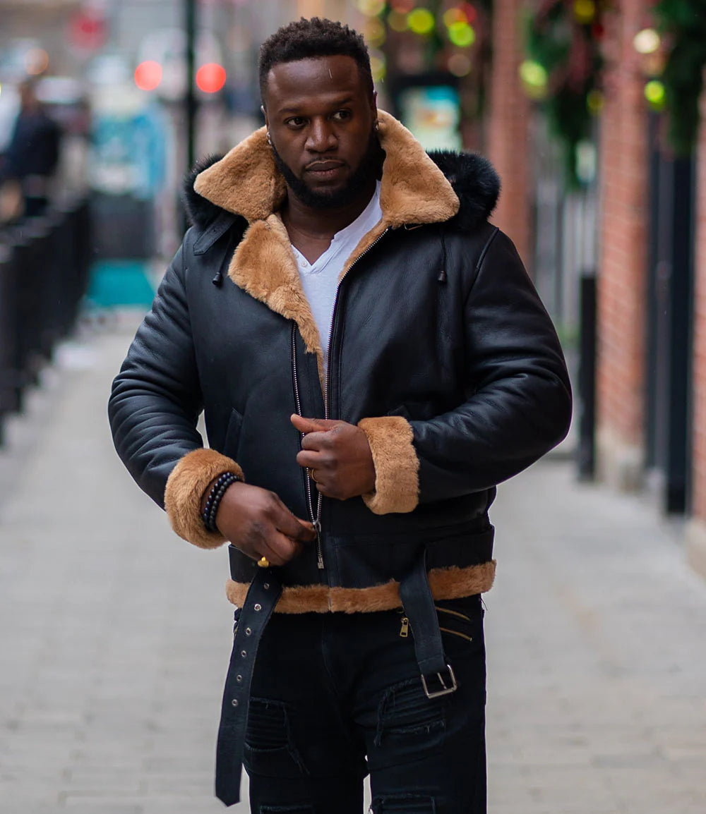 Lifestyle photoshoot of Jean's B3 Bomber Aviator Shearling Jacket with hoodie, worn by a man outdoors, showing tan shearling and leather.