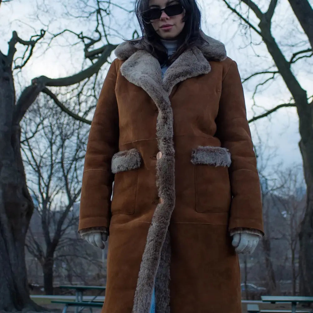 Model wearing the Sabina Tobacco oversized long shearling coat, styled for a chic, winter-ready look.
