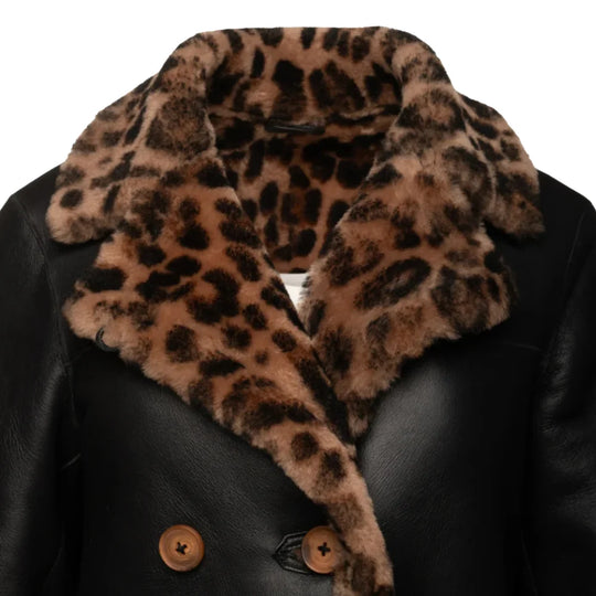 Close-up of the Seraphina coat’s leather texture and leopard print detail, highlighting the premium stitching and button closure.