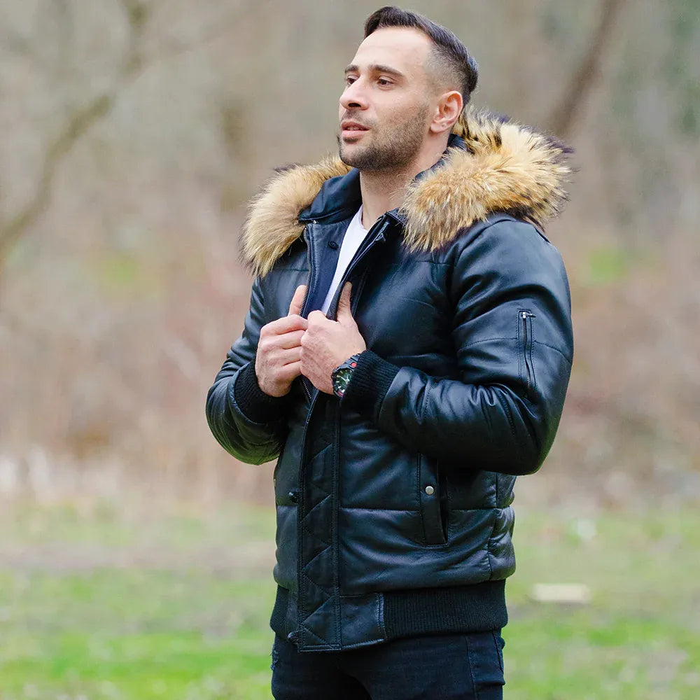 A model wearing the Traynor leather puffer jacket with the hood up, demonstrating the heavy insulation and mid-waist winter silhouette.