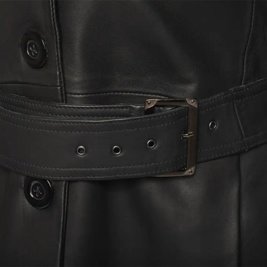 Close-up of a black leather jacket with a belt and buttons.