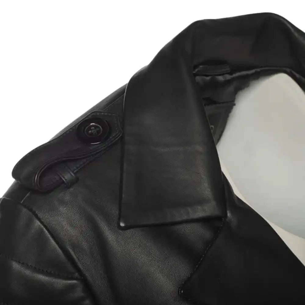 Detailed Close-up of a shoulder for  black leather trench coat on a white background.