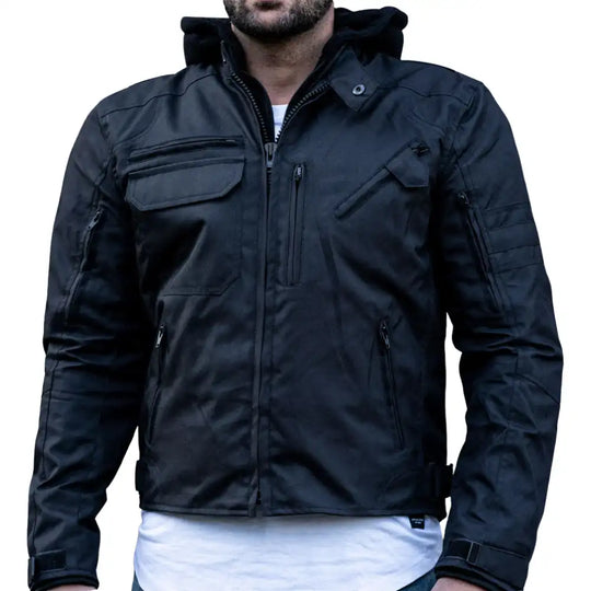 A model riding in rainy conditions wearing the black armored jacket, demonstrating the water-beading effect on the leather and the secure, protective fit.