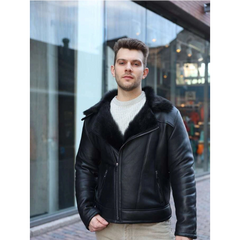 Man wearing a Carter's Toscana Shearling Leather Biker Jacket with fur collar standing in front of a glass building.