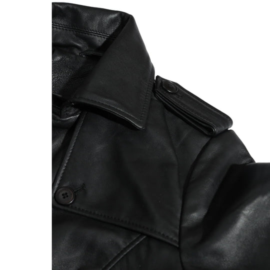 Close-up of a black leather coat with a button on a white background