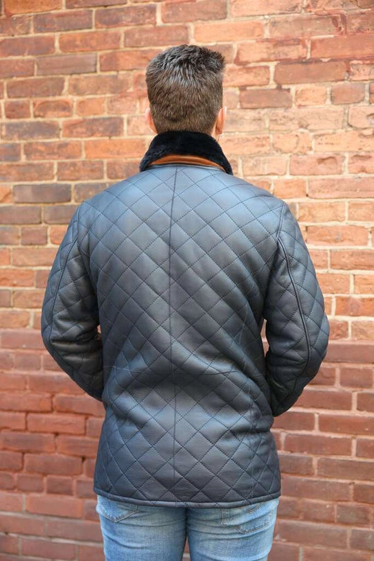 Model wearing Drew Navy Quilted Sheepskin Shearling Coat back view winter coat