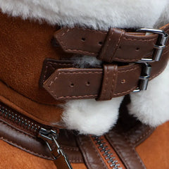Detailed shot of Hagan's Tan Suede Jacket, showcasing the cream shearling collar and stylish leather buckles on the sleeves. The warm shearling provides a luxurious touch, paired with the durable suede leather for a classic aviator design.