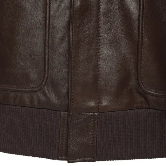 Close-up of a brown leather jacket with visible stitching and texture.