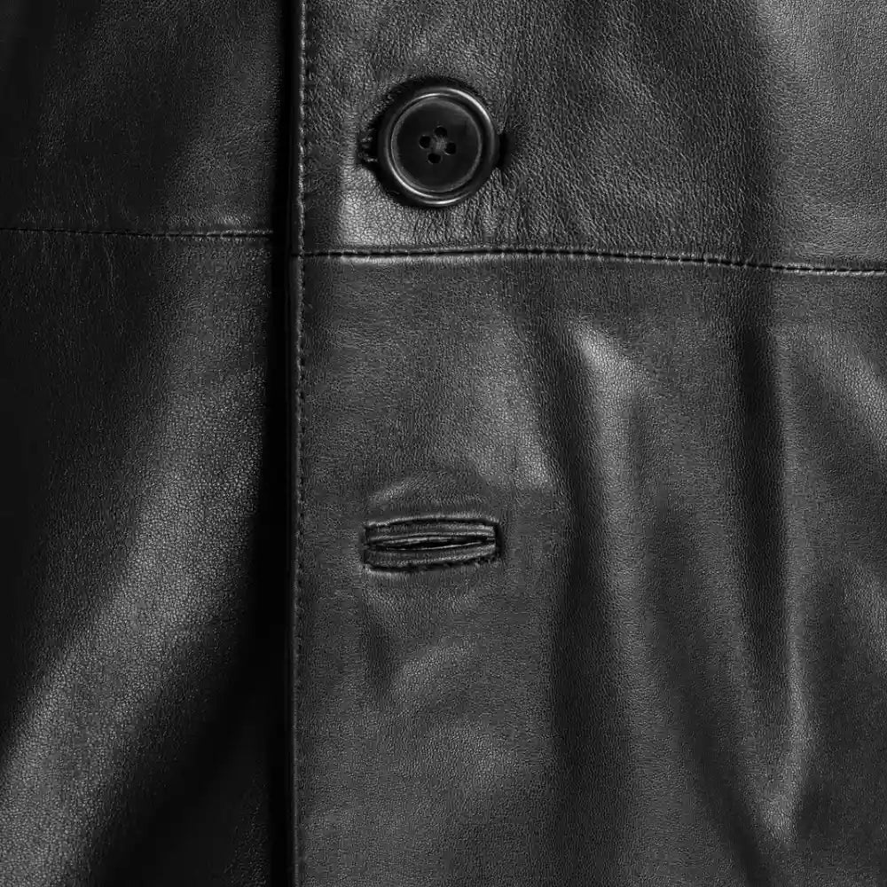 Close-up of the durable, reinforced buttons and buttonholes on the Jensen black leather long coat.