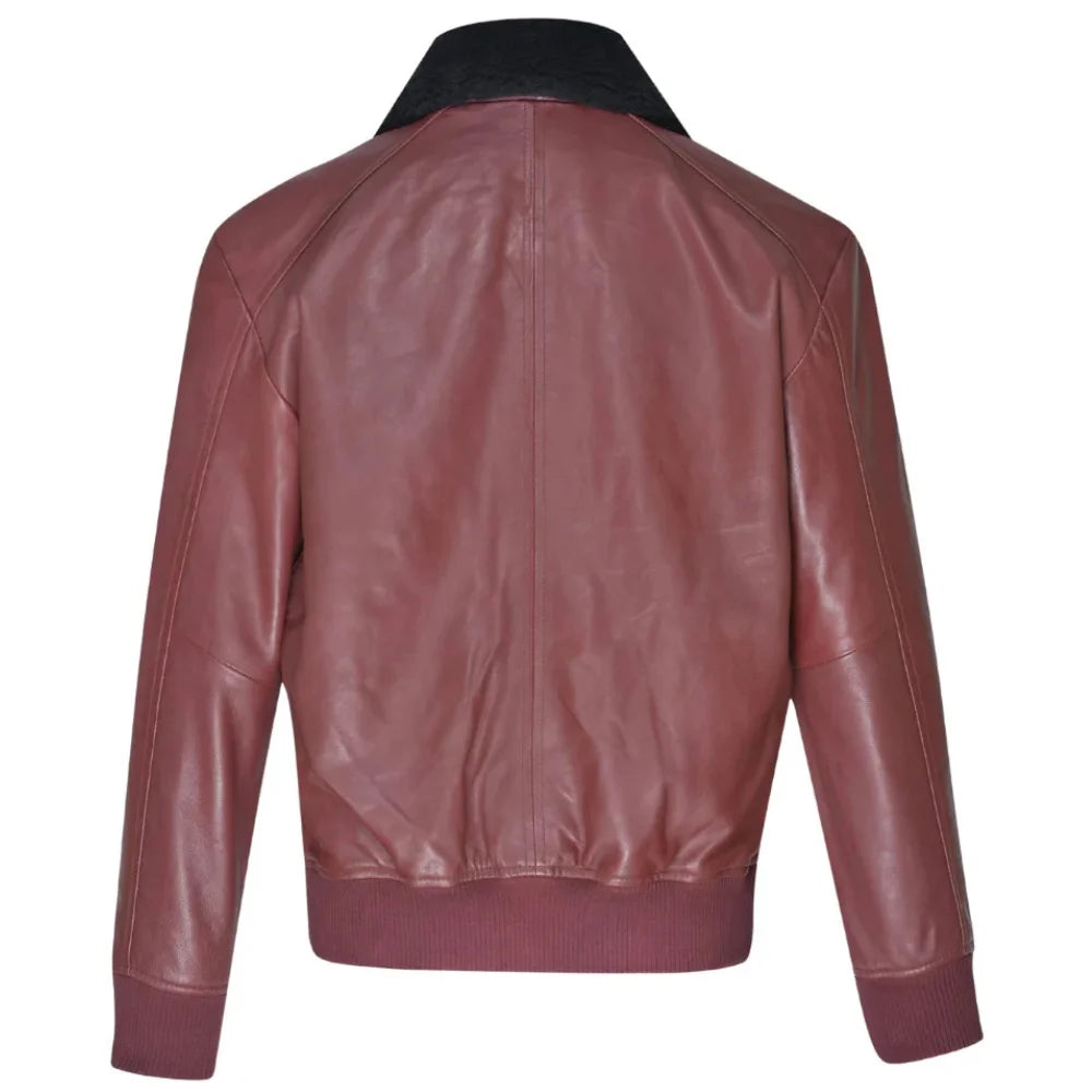 Back view of Justin's burgundy A2 bomber leather jacket featuring a black faux fur collar, ribbed waistband on a white background.