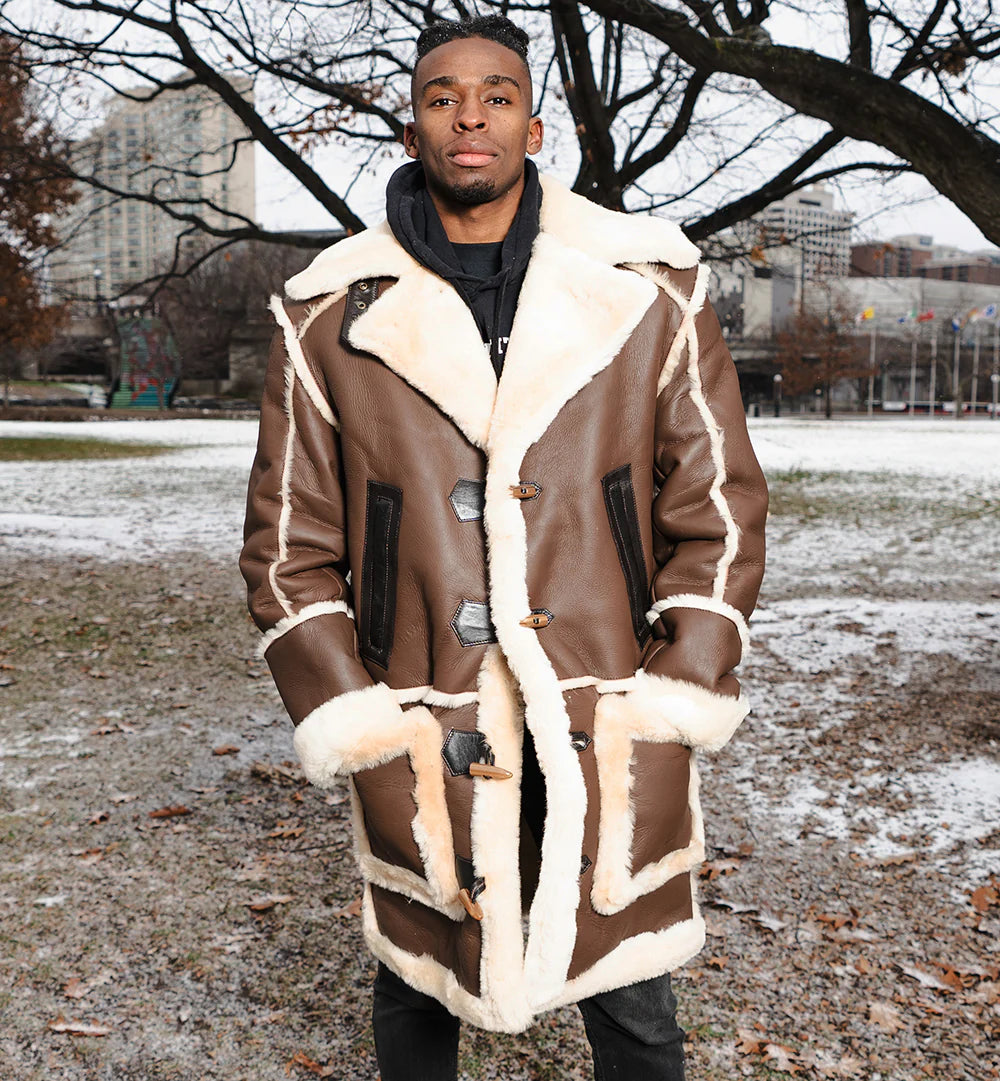 Man wearing a brown shearling coat in an urban park setting