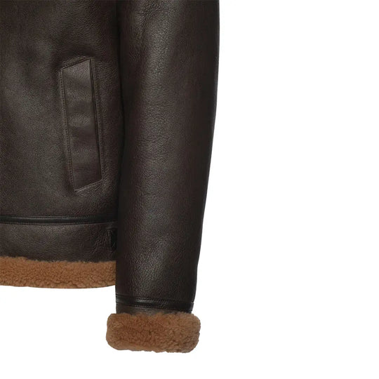 Close-up of the wrist belt and cuff detailing on the Rob Brown B3 Bomber Shearling Jacket. The jacket features brown leather with tan shearling trim at the cuffs, showcasing adjustable straps.