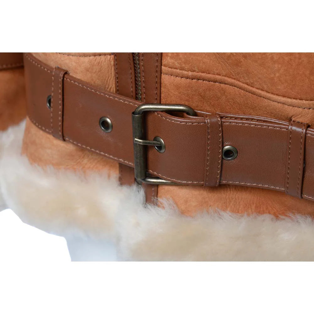 Close-up of a Cognac shearling aviator jacket waist belt with a buckle on a sheepskin surface.