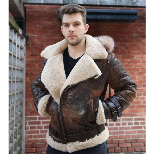 Man wearing Rocco vintage brown aviator shearling jacket with white fur lining against a brick wall.