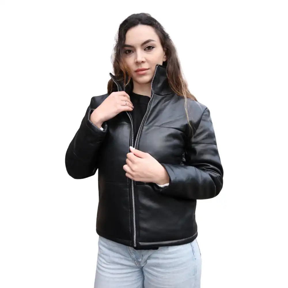 A model wearing the Sorine black leather puffer jacket styled with a turtleneck, showcasing its chic, lightweight yet insulated look.