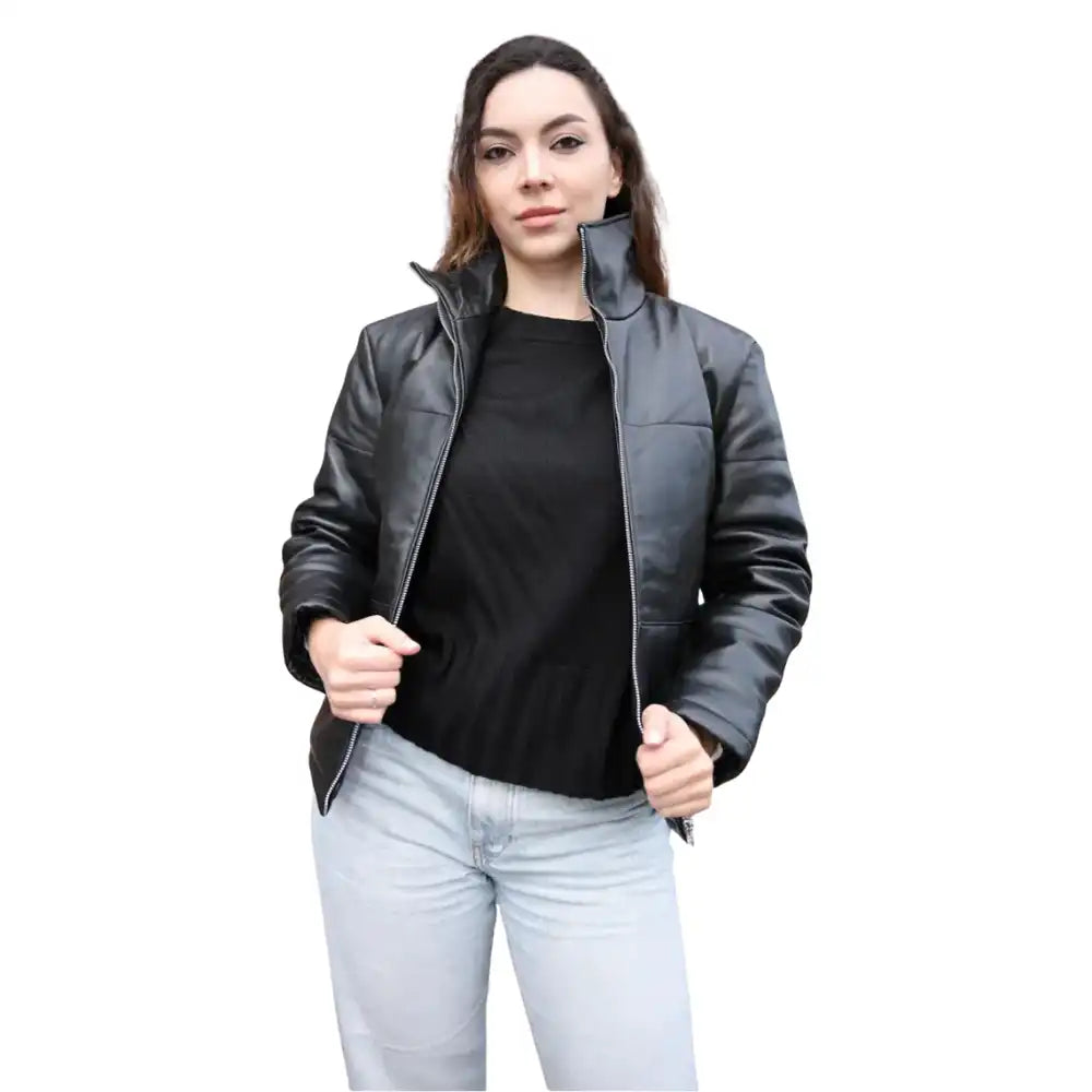 Woman wearing a black leather jacket over a black shirt on a white background