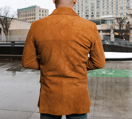Rear view of a Man wearing Wyatt tan suede leather blazer in an urban setting.